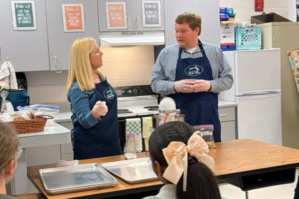 Bake Blue speaking and cooking for the Project Outreach at Baker High School